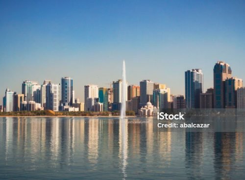 Noor Mosque and jet stream in Khalid Lake, with the city skyline in the background
